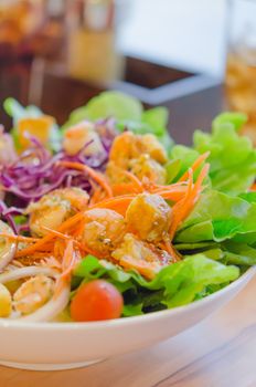 close up  boiled prawn and vegetable salad with  sauce in white bowl