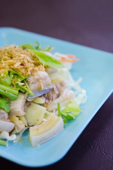  close up steamed fish with fried garlic and fresh vegetable , asian style cuisine