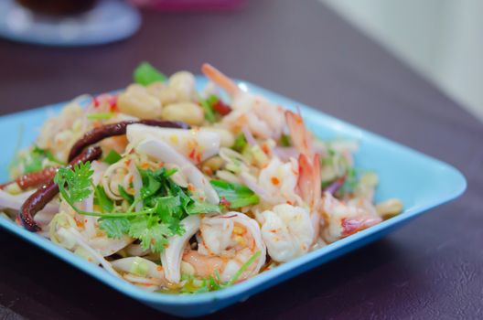  seafood  salad  with shrimp , lemongrass , fried chili  and fresh vegetable  on dish , spicy dish