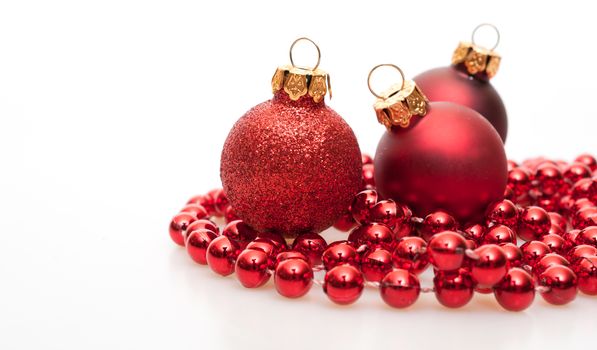 Christmas Background - Red Christmas Baubles on White Background - Shallow Depth of Field