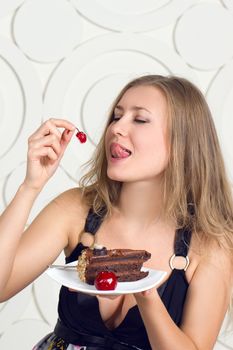 Portrait of young woman enjoying the cake