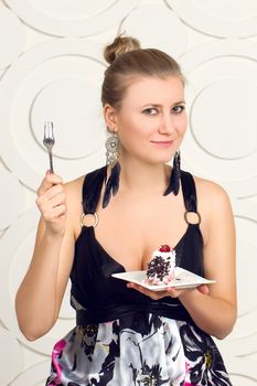 Young beautiful woman eating  chocolate cake.