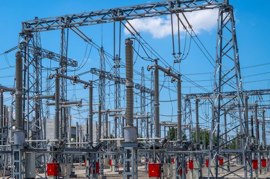 Image of high voltage transformer station against the blue sky.