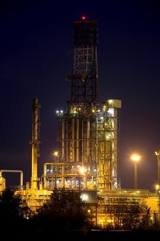 Oil refinery buildings at night