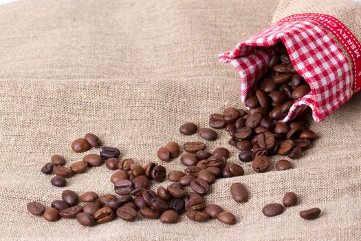 Coffee beans in sack,  burlap background