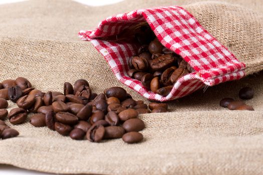 Coffee beans in sack,  burlap background