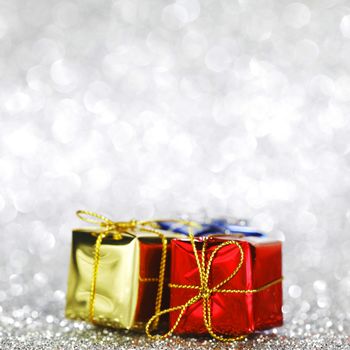 Gift boxes on glitter silver background