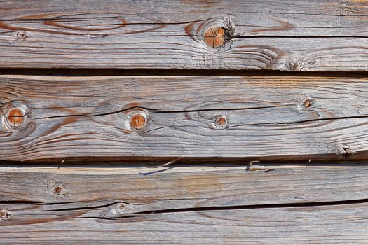 Old wooden logs as a part of wooden house walls