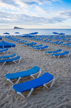 Lots of deckchairs waiting for tourists on Benidorm beach, Costa Blanca, Spain