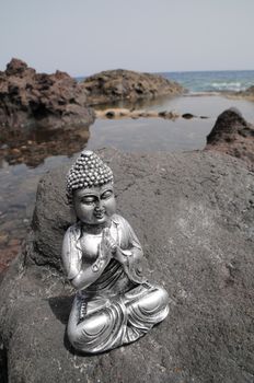 One Ancient Gray Buddha Statue Near The Ocean