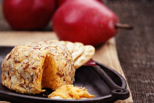 Cheese spread with almonds, crackers and red pears. 