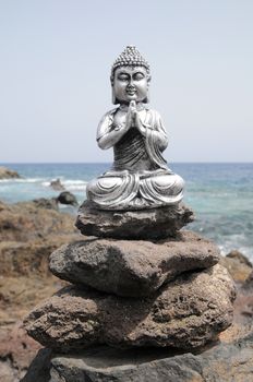 One Ancient Gray Buddha Statue Near The Ocean