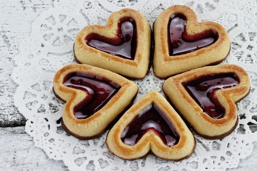Heart shaped shortbread cookies in a circle on a rustic background.