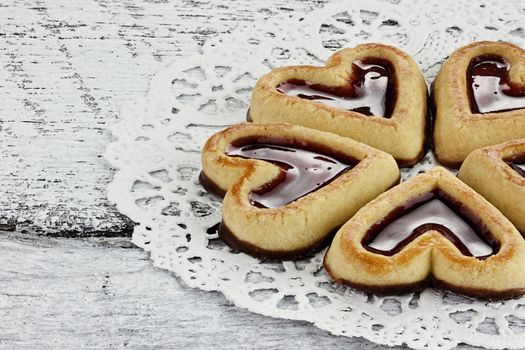 Heart shaped shortbread cookies in a circle on a rustic background.