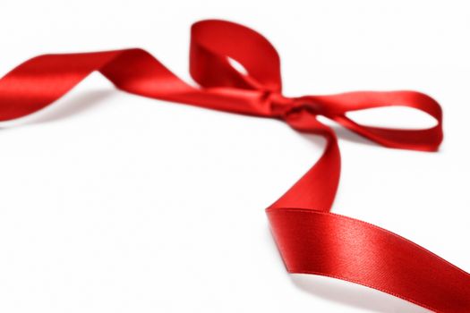 Shiny red satin ribbon on white background