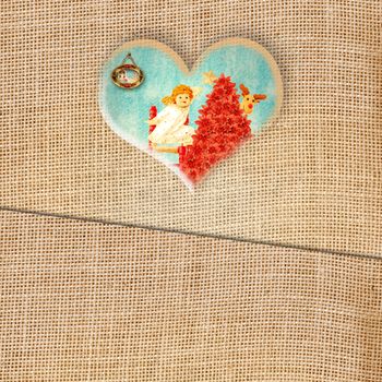 Funny Christmas greeting card, lovely Angel in heart on burlap background