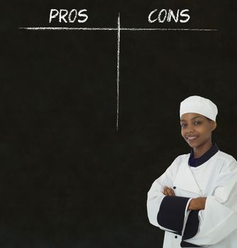 African American woman chef with chalk pros and cons on blackboard background
