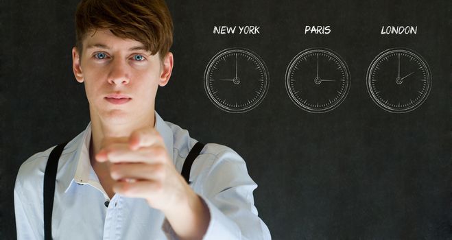 Businessman pointing with New York Paris and London chalk time zone clocks on blackboard background
