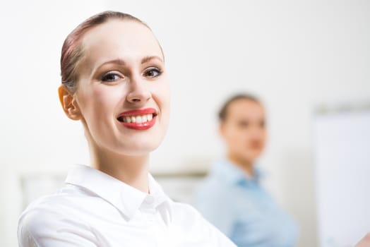 portrait of a business woman in office, smiling and looking into the camera, office work