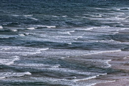 Aerial view of small waves on a beach at the Atlantic Ocean, creating a nice natural pattern.