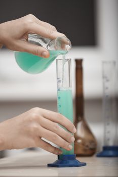 Human hands working in chemical laboratory
