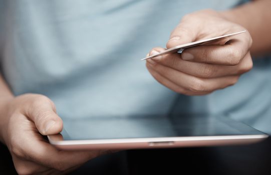 Human hands with digital tablet and credit card