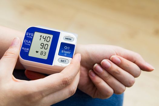 High blood pressure. woman measures the pressure