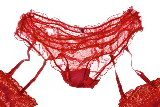 Red lacy panties and openwork stockings isolated on white