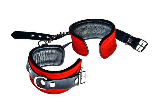 Red leather handcuffs on white background
