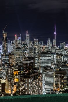 Full view of downtown Toronto at night with glamour lights viewing from a balcony