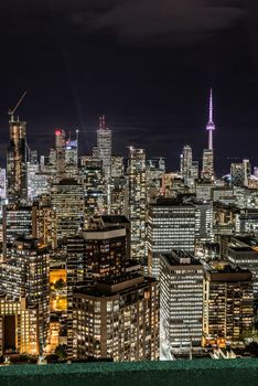 Full view of downtown Toronto at night with glamour lights viewing from a balcony