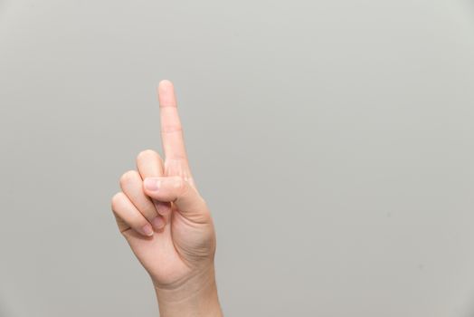 Human hand with one finger sticking up on light gray background