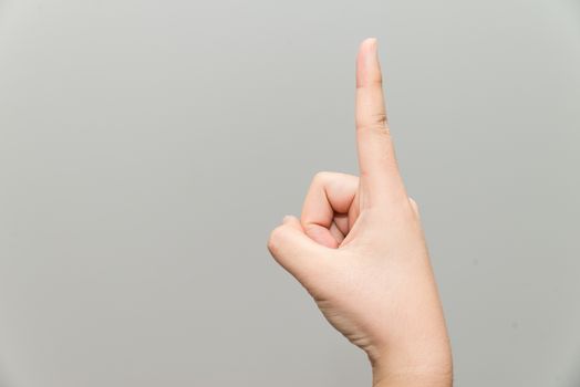 Human hand with one finger sticking up on light gray background