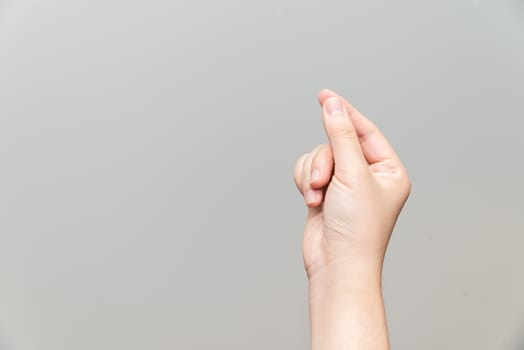 Human hand holding imaginary card on light gray background