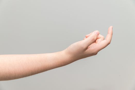 Human hand with curl index finger on light gray background