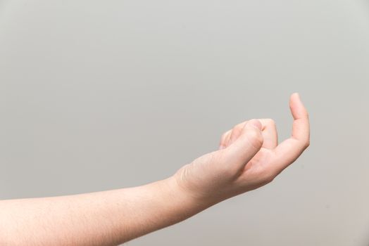 Human hand with curl index finger on light gray background