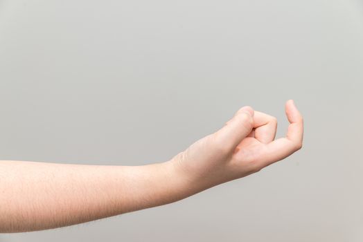 Human hand with curl index finger on light gray background
