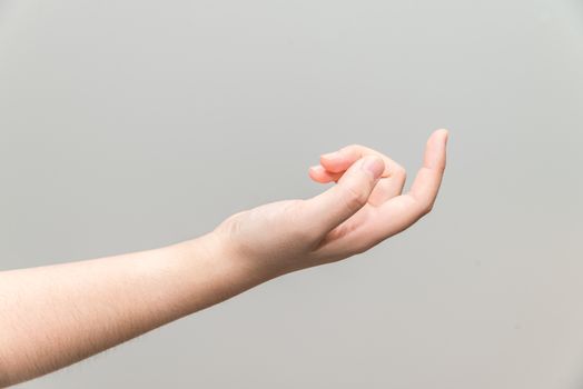 Human hand with curl index finger on light gray background