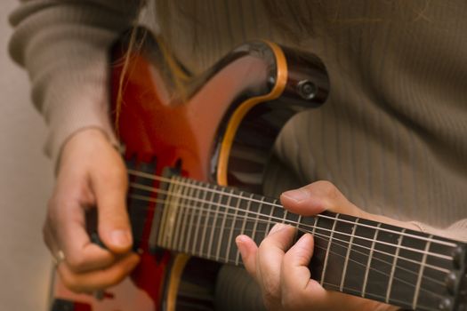 Musician playing a red E-Guitar