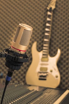 Retro microphone with a white guitar on the background