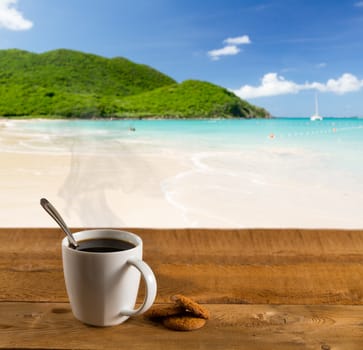 Morning cup of coffee on a wooden picnic table on Anse Marcel beach on St Martin in Caribbean in idyllic dreamlike location