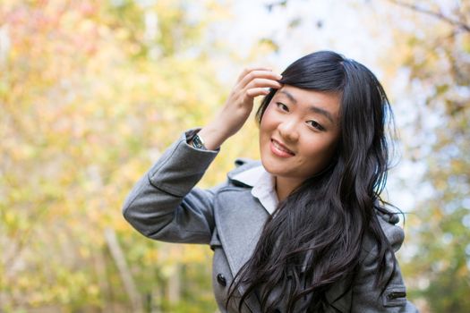 Portrait of young beautiful girl bending forward and tilting her head