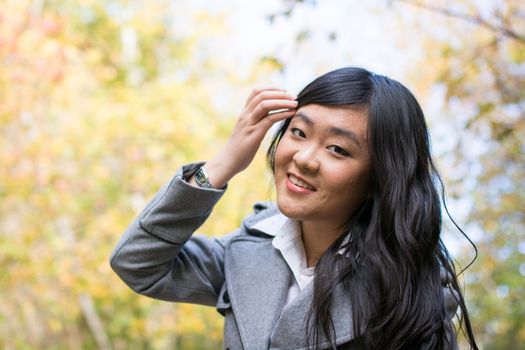 Portrait of young beautiful girl bending forward and tilting her head