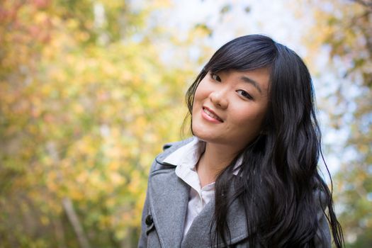 Portrait of young beautiful girl bending forward and tilting her head