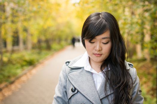 Close up portrait of attractive young girl alone on a road looking depressed