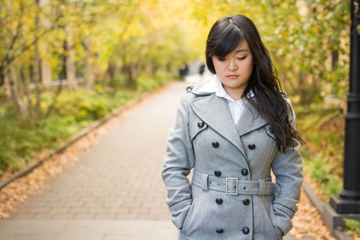 Close up portrait of attractive young girl alone on a road looking depressed