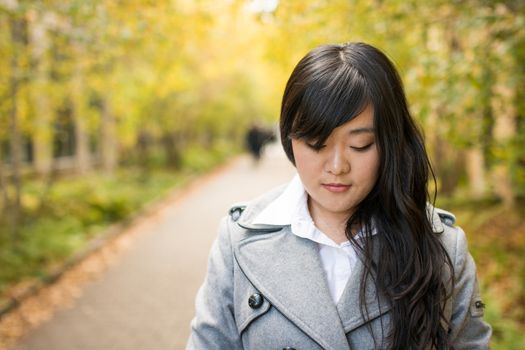 Close up portrait of attractive young girl alone on a road looking depressed