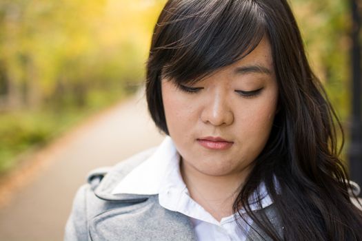 Close up portrait of attractive young girl alone on a road looking depressed
