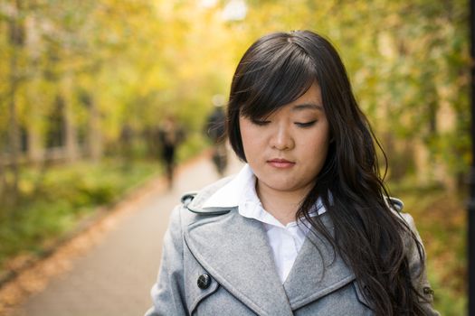 Close up portrait of attractive young girl alone on a road looking depressed