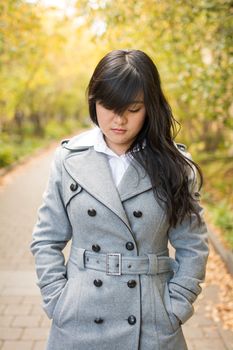 Close up portrait of attractive young girl alone on a road looking depressed